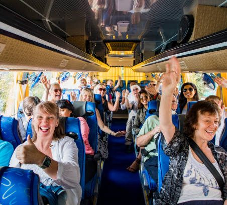 A group of people with various complex needs enjoying a day out on the bus